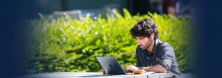 Student on laptop outside