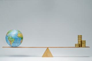 Balance with globe on one side and gold coins on another