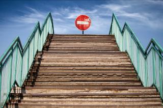 Stop sign at the end of a tall staircase