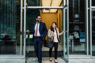 Two people walking out of a builidng