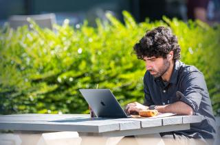 Student on laptop outside