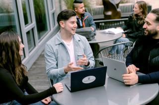 JD students sitting outside at a table talking