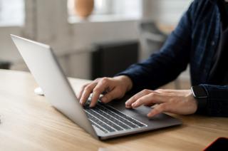 Person typing on laptop